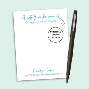 May include: A white notepad with teal text reading A note from the mom of, followed by the names Harper, Liam, and Sophia, and the name Madelyn Cooper with contact details. A black pen rests beside it, with a circle graphic stating MULTIPLE COLOR CHOICES.
