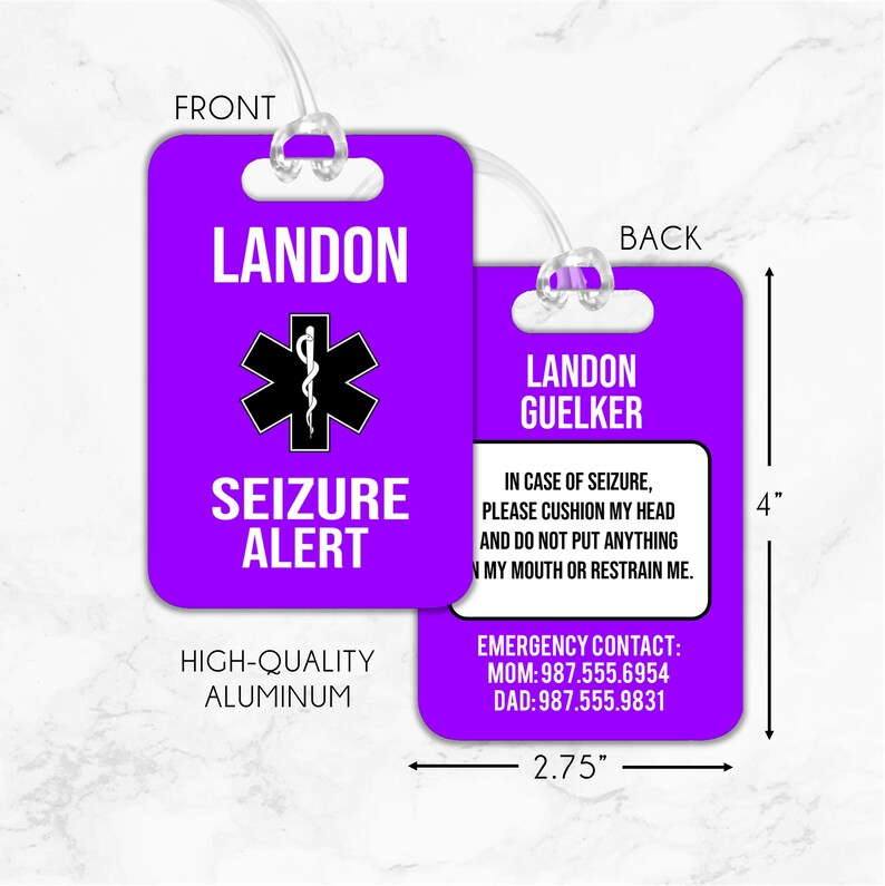 May include: Purple luggage tag with a black medical symbol and the text "LANDON SEIZURE ALERT". The back of the tag has the text "LANDON GUELKER" and instructions for medical assistance in case of a seizure. The tag is made of high-quality aluminum and measures 2.75 inches by 4 inches.