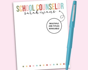 May include: A white notepad with the text SCHOOL COUNSELOR in multicolored letters and the name Sarah Evans in black script. A circle with an arrow points to the text with the words MULTIPLE JOB TITLES AVAILABLE. A teal pen sits beside the notepad.
