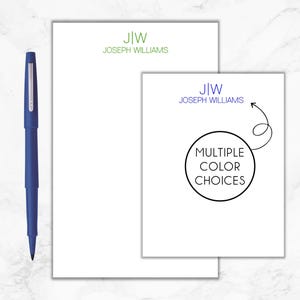 May include: Two white notepads with green text that reads "J|W JOSEPH WILLIAMS". The smaller notepad has a black circle with the text "MULTIPLE COLOR CHOICES" and a black arrow with a swirl at the end.