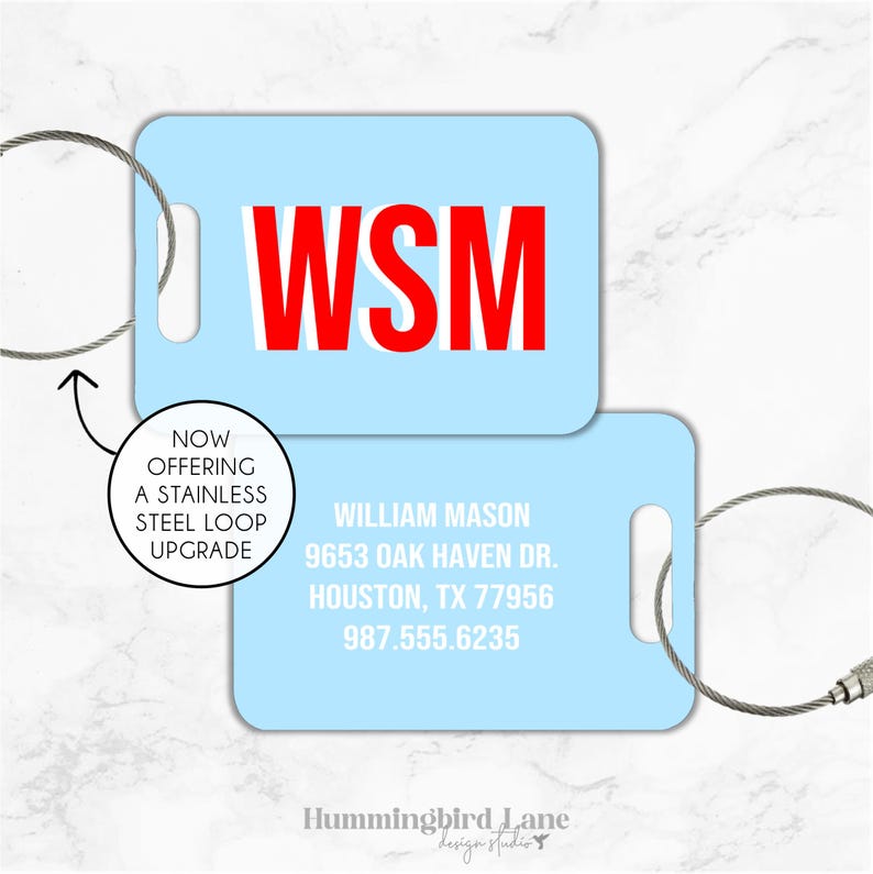 May include: Light blue luggage tag with a white loop and a red WSM monogram. The tag also includes the text "William Mason, 9653 Oak Haven Dr., Houston, TX 77956, 987.555.6235".