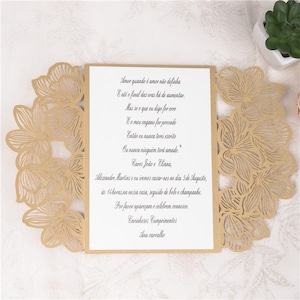 May include: A gold laser cut wedding invitation with a floral design. The invitation text reads "Amor quando &eacute; amor n&atilde;o definha E at&eacute; o final das eras h&aacute; de aumentar. Mas se o que eu digo for erro E o meu engano for provado Ent&atilde;o eu nunca terei escrito Ou nunca ningu&eacute;m ter&aacute; amado." Cares Jo&atilde;o e Eliana, Mezandre. Martins and I are getting married on the 5th of August, at 2 pm at our house, followed by cake and champagne. Please come and celebrate with us. Warmest Regards Ana carvalho"