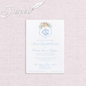 May include: Wedding invitation with a blue and white floral design. The invitation reads "Together with their families, Sarah Elizabeth Comstock and Charles Thomas Bingham invite you to share in their joy as they are united in marriage Saturday, the twenty-fifth of April two thousand twenty-six at five o'clock The Springs Parker Manor 454 Thompson Road Weatherford, Texas Dinner and dancing to follow Semi-formal attire"