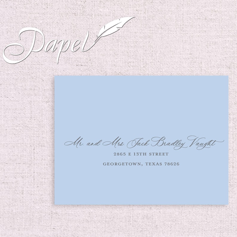 May include: A light blue envelope with a white feather and the text "Papel" in a cursive font. The address is written in cursive: "Mr and Mrs. Jack Bradley Vaught, 2865 E 13TH STREET, GEORGETOWN, TEXAS 78626."