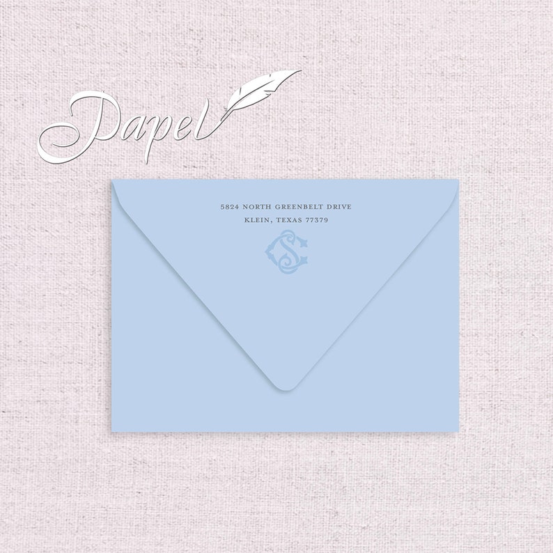 May include: A light blue envelope with a white feather and the word "Papel" in cursive. The address is 5824 North Greenbelt Drive, Klein, Texas 77379.
