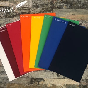 May include: A collection of colorful paper sheets, including white, maroon, red, orange, gold, green, royal blue, and navy. Each sheet is labeled with its color name. The word "Papel" is written in cursive at the top left.