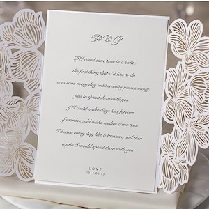 May include: White wedding invitation with a laser-cut floral design. The invitation features a poem about love and the text "W&B" and "LOVE 2014.06.13".