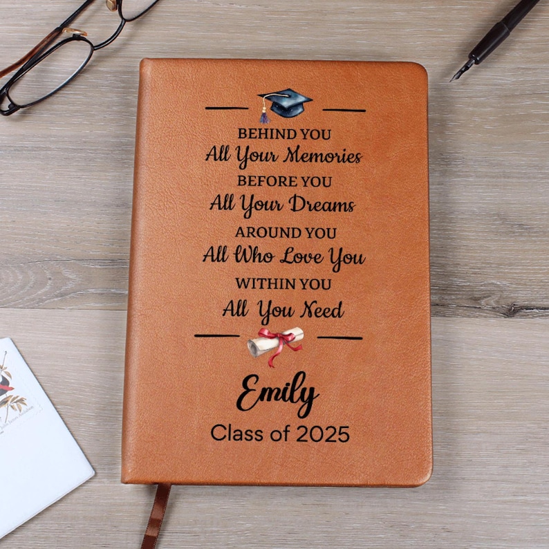 A brown journal with black text and two graduation icons
