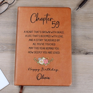 May include: A brown leather journal with the text "Chapter 59" and a floral design. The journal includes the text "Happy Birthday, Olivia" and a heartfelt message. A thoughtful gift for a special birthday.