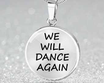 May include: Silver necklace with a round pendant that says "WE WILL DANCE AGAIN".