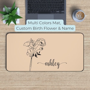 May include: A personalized mousepad with a light brown background featuring a black line drawing of a bouquet of flowers and the name "ashley".
