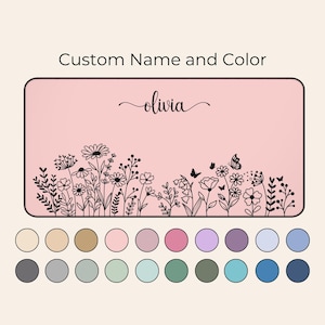 May include: A pink background with a black outline of flowers and butterflies. The text "olivia" is written in cursive at the top of the image. A color palette of 20 different colors is shown below the image.