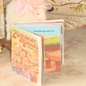 May include: A colourful children's book titled "20 Hungry Piggies: A Number Book" with illustrations of pigs. The book is open to a page with a picture of a mushroom.