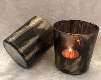 black and gold decorated candle holder with tealight candle