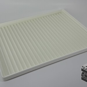 May include: A rectangular, off-white air filter with a pleated design. The filter has a white frame and is set against a light gray background. The EMB 3D logo is in the bottom right corner.