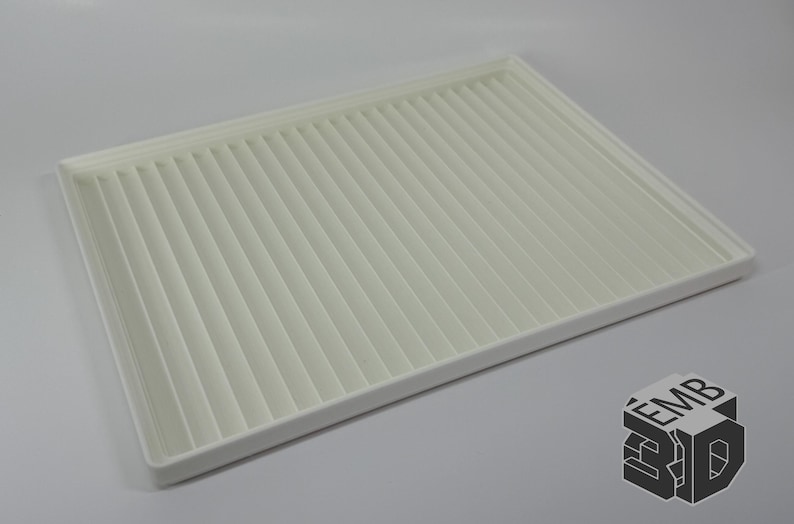 May include: A rectangular, off-white air filter with a pleated design. The filter has a white frame and is set against a light gray background. The EMB 3D logo is in the bottom right corner.