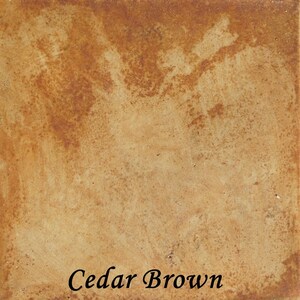 May include: A close-up of a textured, brown surface with a light brown color. The surface has a mottled appearance with darker brown spots. The text "Cedar Brown" is printed in black at the bottom of the image.