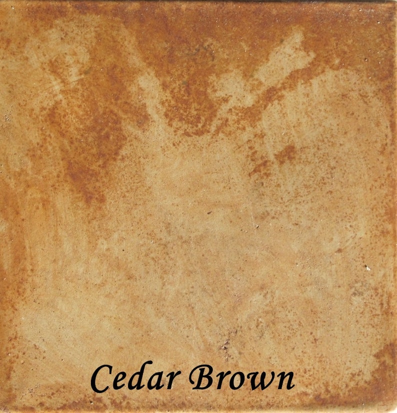 May include: A close-up of a textured, brown surface with a light brown color. The surface has a mottled appearance with darker brown spots. The text "Cedar Brown" is printed in black at the bottom of the image.