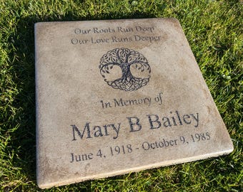 May include: A light brown square concrete memorial stone with a Celtic tree of life design and the inscription "Our Roots Run Deep Our Love Runs Deeper In Memory of Mary B Bailey June 4, 1918 - October 9, 1985".