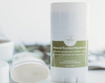 May include: White deodorant stick with a green label that reads "Mineral Enriched Deodorant". The image also shows a white bowl, a deodorant stick with the cap off, and a rolled-up white towel. The deodorant is 2.6 oz (73ml).