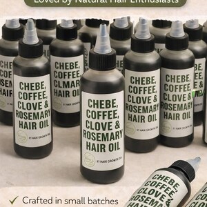 May include: Bottles of herbal hair oil with the text "CHEBE, COFFEE, CLOVE & ROSEMARY HAIR OIL." The bottles are dark with white labels and a clear applicator tip. The image also includes the text "Loved by Natural Hair Enthusiasts."
