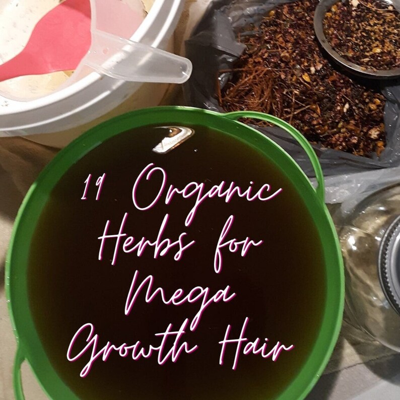May include: A green bucket filled with a dark liquid, with the text "19 Organic Herbs for Mega Growth Hair" in pink script. Other containers hold dried herbs and a pink scoop.