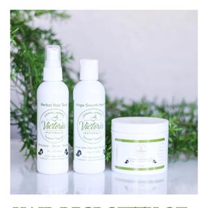 May include: Three white bottles and a jar of hair products from Victoria Naturals. The bottles are labeled "Herbal Hair Tonic" and "Mega Growth Hair". The jar is labeled "Olive Oil Hair Growth". The text "HAIR REGROWTH OIL" is at the bottom.