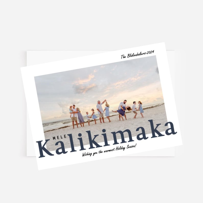 May include: Holiday card with a family photo on a beach. The card features the text "MELE Kalikimaka" in navy blue, with the words "Wishing you the warmest Holiday Season!" below. The family is dressed in light colors.