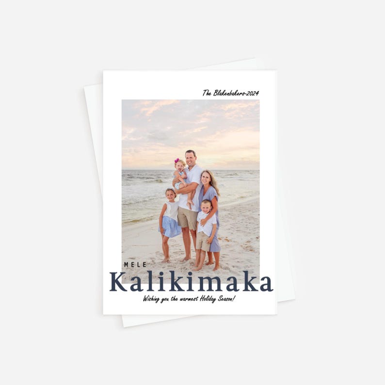 May include: A white holiday card featuring a family photo on a beach. The card includes the text "The Blakesbehrs-2024" at the top and "MELE Kalikimaka Wishing you the warmest Holiday Season!" at the bottom. The family is standing on the beach.