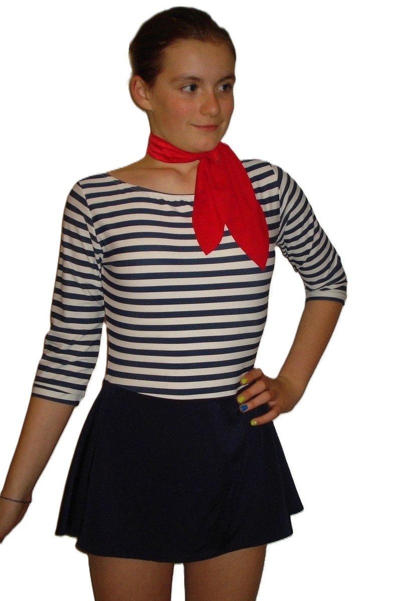 May include: A nautical-themed outfit featuring a striped long-sleeve shirt with navy blue and white horizontal stripes, paired with a navy blue skirt. A bright red scarf is tied around the neck. The outfit is suitable for a costume or themed event.