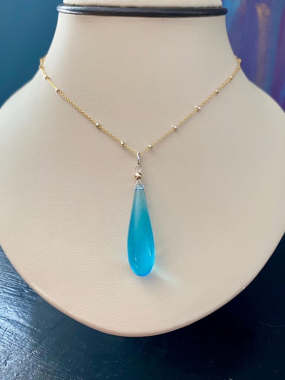 Blue Topaz tear drop pendant on a 18” two tone 14k yellow gold filled and sterling silver satellite link chain. * Rain Drop Collection