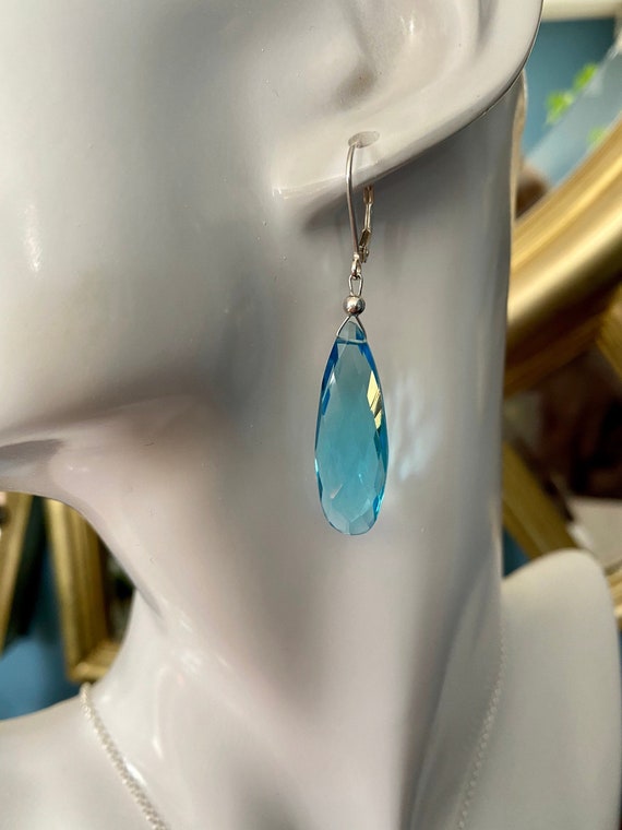 Beautiful long tear drop shaped Blue Topaz dangle earrings with sterling silver leverbacks. December’s birthstone.