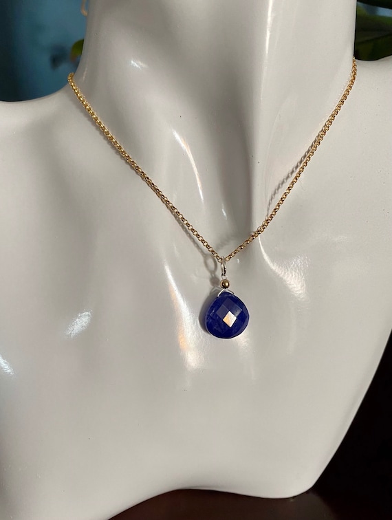 Blue Sapphire pendant on a 18” yellow gold filled or sterling silver rolo link chain.