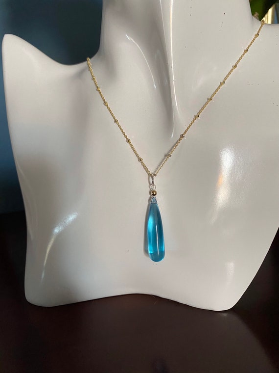 Blue Topaz tear drop pendant on a 18” two tone 14k yellow gold filled and sterling silver satellite link chain. * Rain Drop Collection