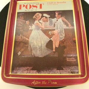 May include: A red metal serving tray with a gold trim features a vintage illustration of a couple leaving a diner after prom. The tray has the text "The Saturday Evening POST" and "May 25, 1957" printed on the top left corner. The text "I Call on Groucho" is printed on the top right corner. The text "After the Prom" is printed in gold on the bottom of the tray.