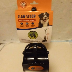 May include: Black plastic pet waste scoop with an extending handle. The packaging shows a dog and the text "Claw Scoop with Extending Handle".