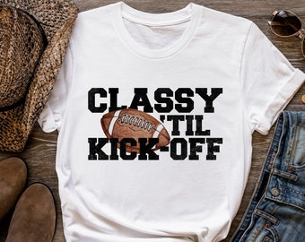 May include: White t-shirt with a black graphic that says "Classy til Kick-Off" and a football graphic.