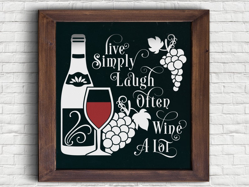 May include: A framed chalkboard sign with a white background and black text. The text reads "Live Simply Laugh Often Wine A Lot". The sign also features a white silhouette of a wine bottle, a wine glass, and grapes.