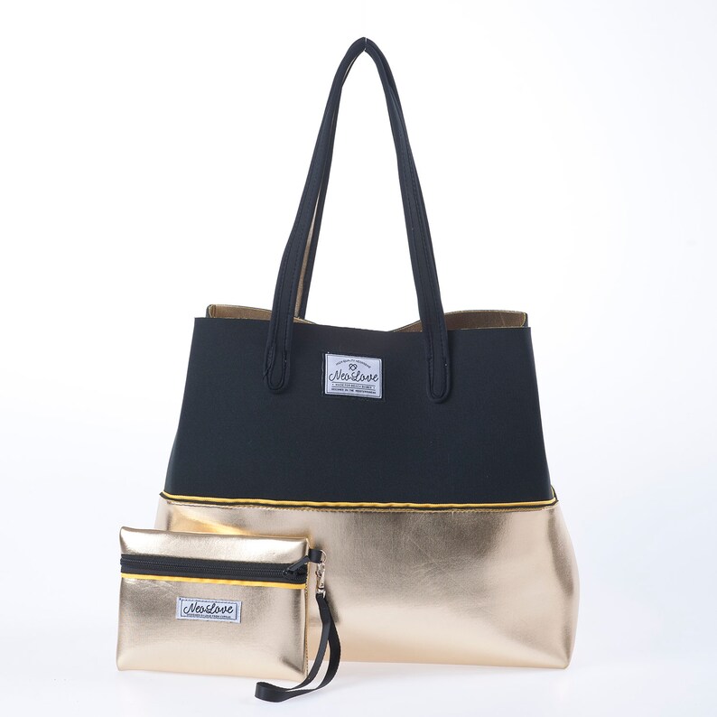 May include: A black and gold tote bag with a zippered pouch. The tote bag has a black top section and a gold bottom section. The pouch is gold with a black zipper. Both the tote bag and pouch have a yellow trim and a white logo that says "MaxLove".
