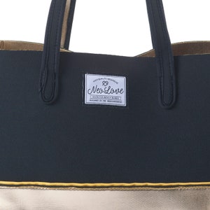 May include: Black and gold tote bag with a black label that says "High Quality Neoprene Neo Love Made for Beach Babes Designed in the Mediterranean".