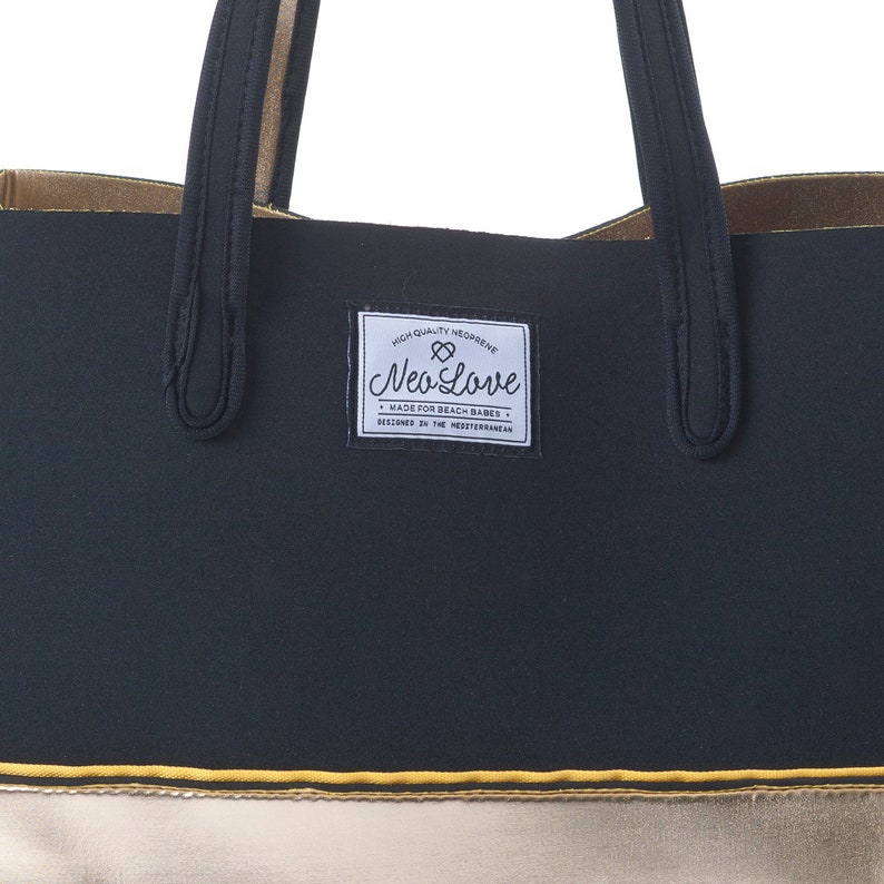 May include: Black and gold tote bag with a black label that says "High Quality Neoprene Neo Love Made for Beach Babes Designed in the Mediterranean".