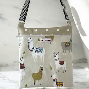 Crossbody Peg Bag - Alpacas. Cross body/Shoulder Style made in Funky Alpacas matt Oilcloth fabric. Two colours available. Strong and sturdy.