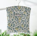 Oilcloth Peg Bag: Meadow Flowers Denim & Yellow Colourway.  Mini flowers on a light cream background.
