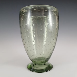 May include: A green glass vase with a textured bubble design and a round base.