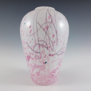 May include: White glass vase with pink and blue splatter paint and streaks.