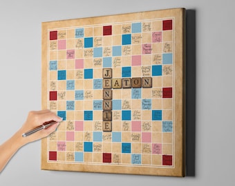 May include: A vintage-style Scrabble board with a light brown background and blue and pink squares. The letters "JENNIE EATON" are spelled out in wooden tiles on the board. The board is covered in handwritten messages.