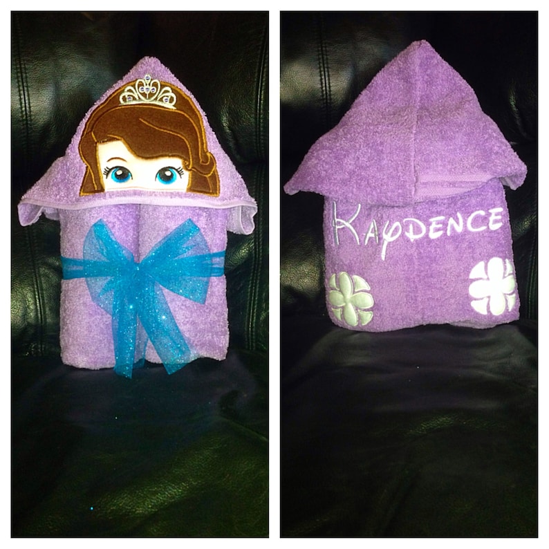 May include: Purple hooded towel with a princess character embroidered on the hood and the name "KADENCE" embroidered on the front.