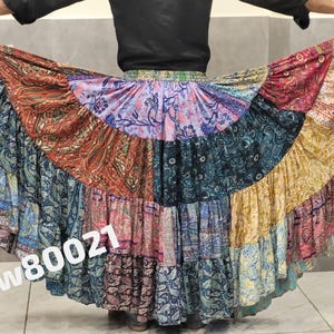 May include: A patchwork skirt with a vibrant mix of colors and patterns, including paisley and floral designs. The skirt features a tiered, flowing silhouette. The text "Pw80021" is visible on the skirt.