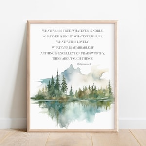 May include: A framed art print featuring a watercolor landscape with a lake and trees. The artwork includes text from Philippians 4:8. The color palette includes shades of green, blue, and beige, creating a serene and natural aesthetic.