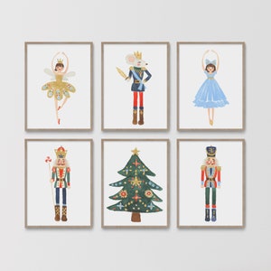 May include: A set of six framed watercolour prints featuring a fairy in a gold dress, a mouse in a crown and uniform, a dancer in a blue dress, a nutcracker with a red jacket, a decorated Christmas tree, and a nutcracker in a blue uniform.